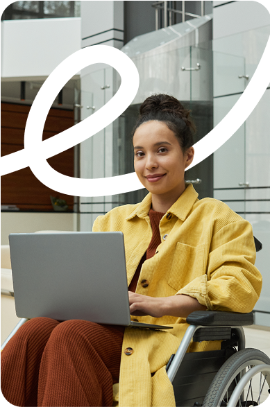 Woman in wheelchair using laptop